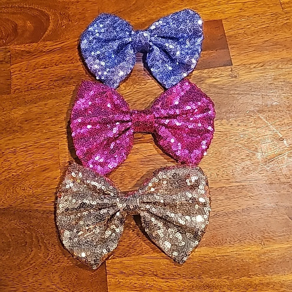 Set of three sequined bow hair clips. Purple pink and gold. Like new